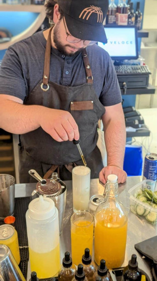 Chef Maxime mixes a cocktail at Maqahamok - Pub wolastoqey, Quebec, Canada.